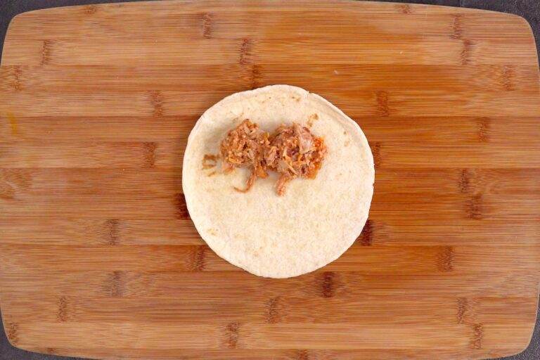 Place a few tablespoons of filling along one edge of the tortilla.