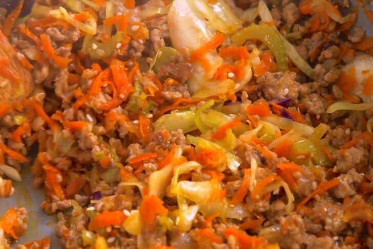 First, cook pork filling with shredded cabbage and carrot.