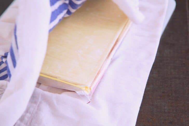 Once filling mixture cools, begin assembling egg rolls. Keep wrappers covered with a damp cloth to prevent drying out.