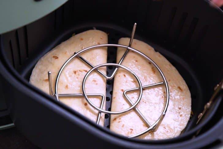Fold over each air fryer quesadilla and place into basket of preheated air fryer. Place a metal trivet on top to prevent tortillas from flying open.
