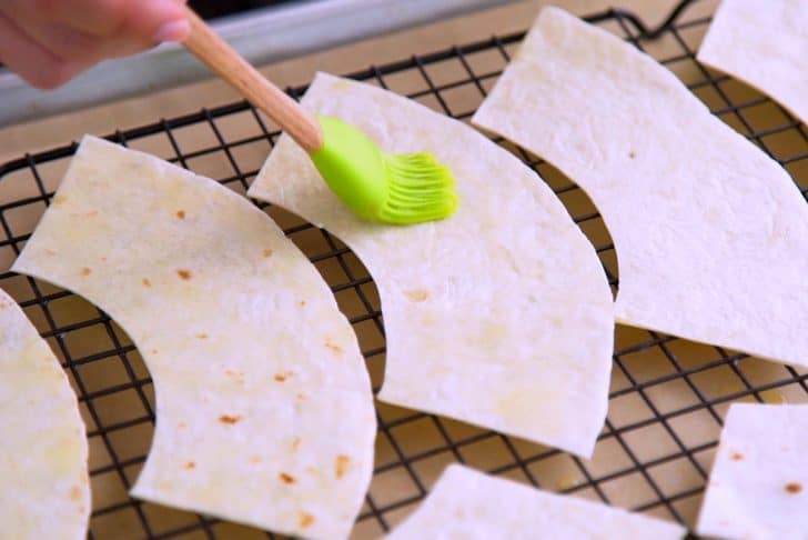 Brush both sides of each tortilla piece with melted butter.