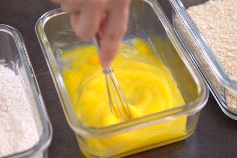 Set up a dredging station with 3 shallow dishes: one filled with flour, one with whisked eggs, and one with panko breadcrumbs and salt.