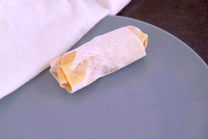 Cover assembled egg rolls with a damp cloth to prevent drying out.
