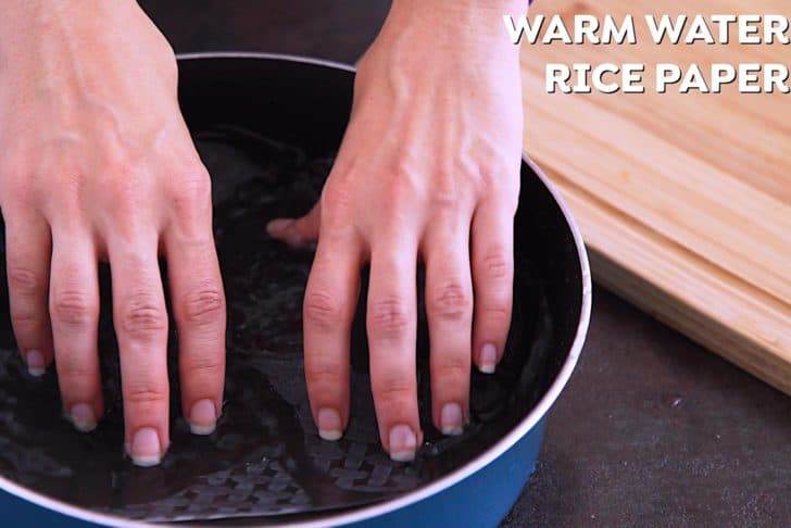 Submerge rice paper in warm water and spin for 15 seconds, then transfer to a flat surface with the textured side facing up.