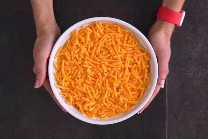 Top with reserved cheddar cheese and bake at 400°F (200°C) for 25-30 minutes.
