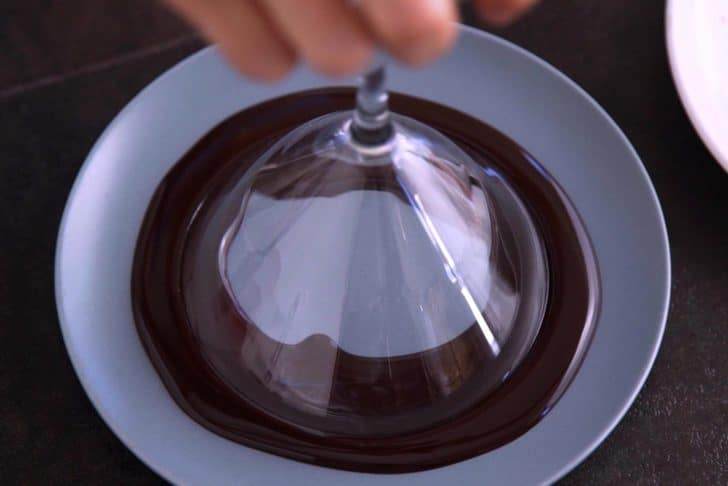 Dip rim of martini glass into chocolate syrup.