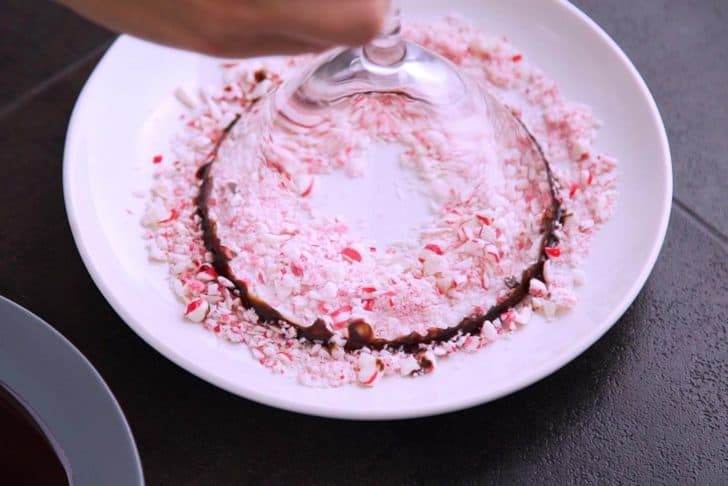 Dip chocolate-coated rim into crushed peppermint candies. Transfer to the fridge to set until ready to serve drinks.