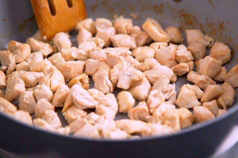 In the meantime, cook chopped chicken breast or thighs until browned on all sides (~7-8 minutes).