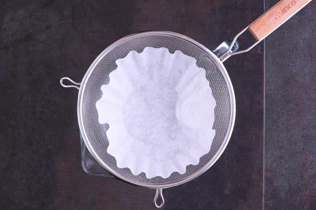Line fine mesh sieve to strain cold brew concentrate