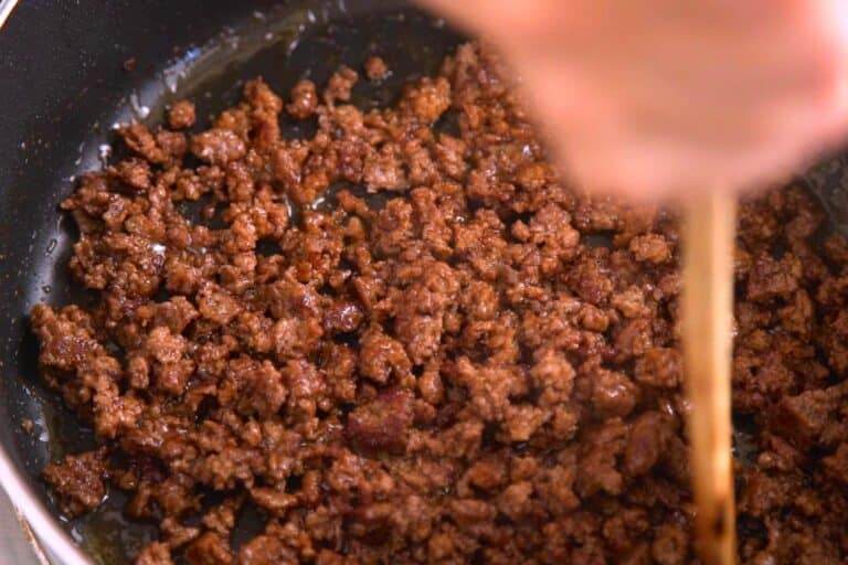 Cook ground meat of choice with taco seasoning, crumbling into small pieces like Taco Bell's meat.
