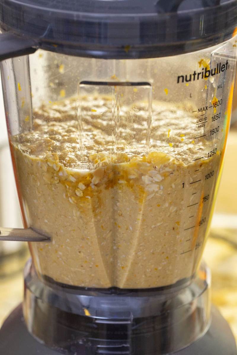 Cranberry orange muffin ingredients being blended up in a blender.