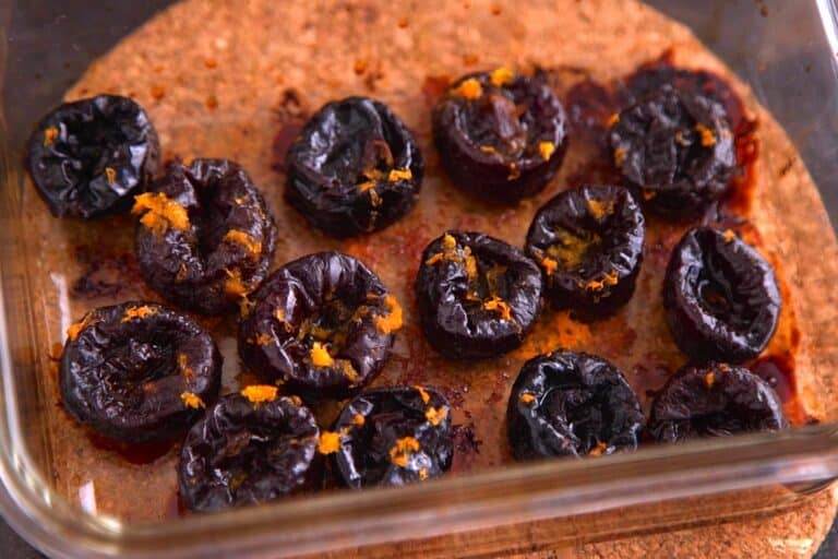 Place whole prunes in a baking dish with orange juice & zest, cover the dish with foil, and roast at 425°F for 15-20 minutes.
