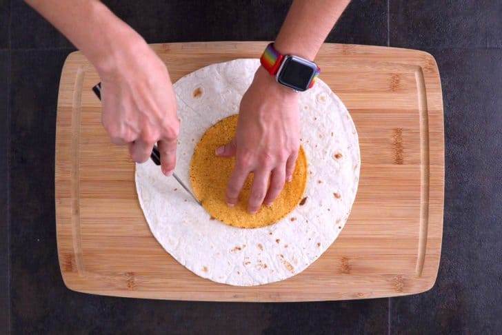 Use tostada shell as a mold to cut small tortilla circles out of half of your larger tortillas.