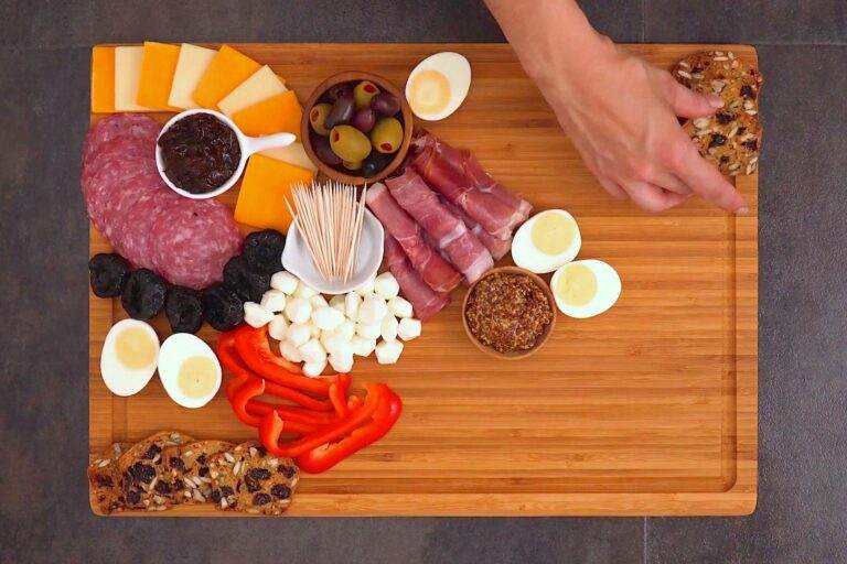Add crackers, fruits & veggies, continuing to fill the space on your board.