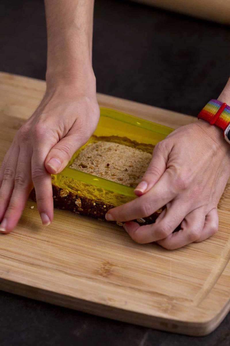 Press outer shape of sandwich sealer onto bread to cut sandwich and remove crusts.