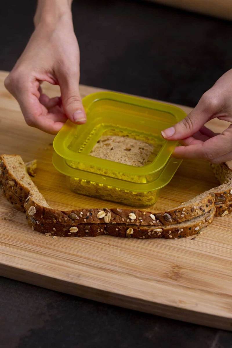 Use sealer to press edges of uncrustables sandwich until crimped and closed.