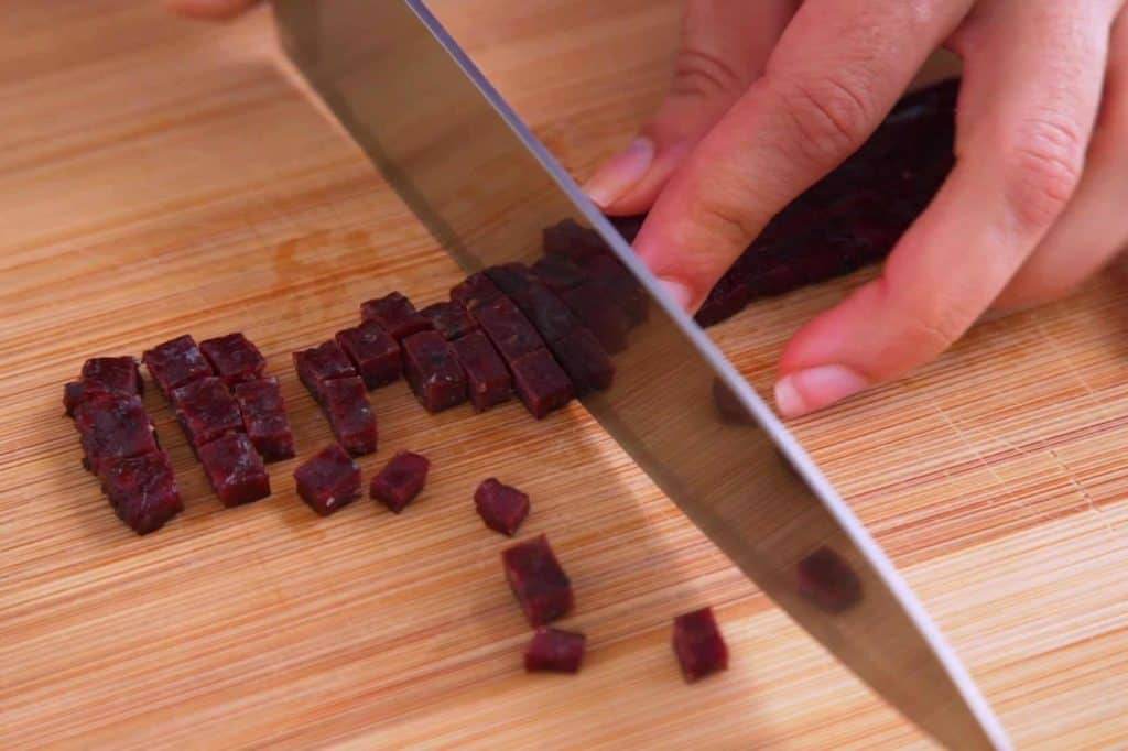 Finely chop beef jerky and soften in boiling hot