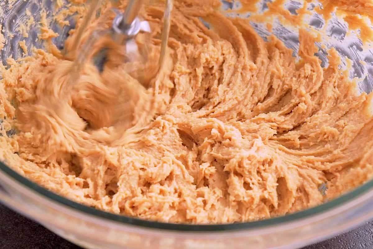 Cream together peanut butter, softened butter, and sugar with a hand mixer until fluffy.