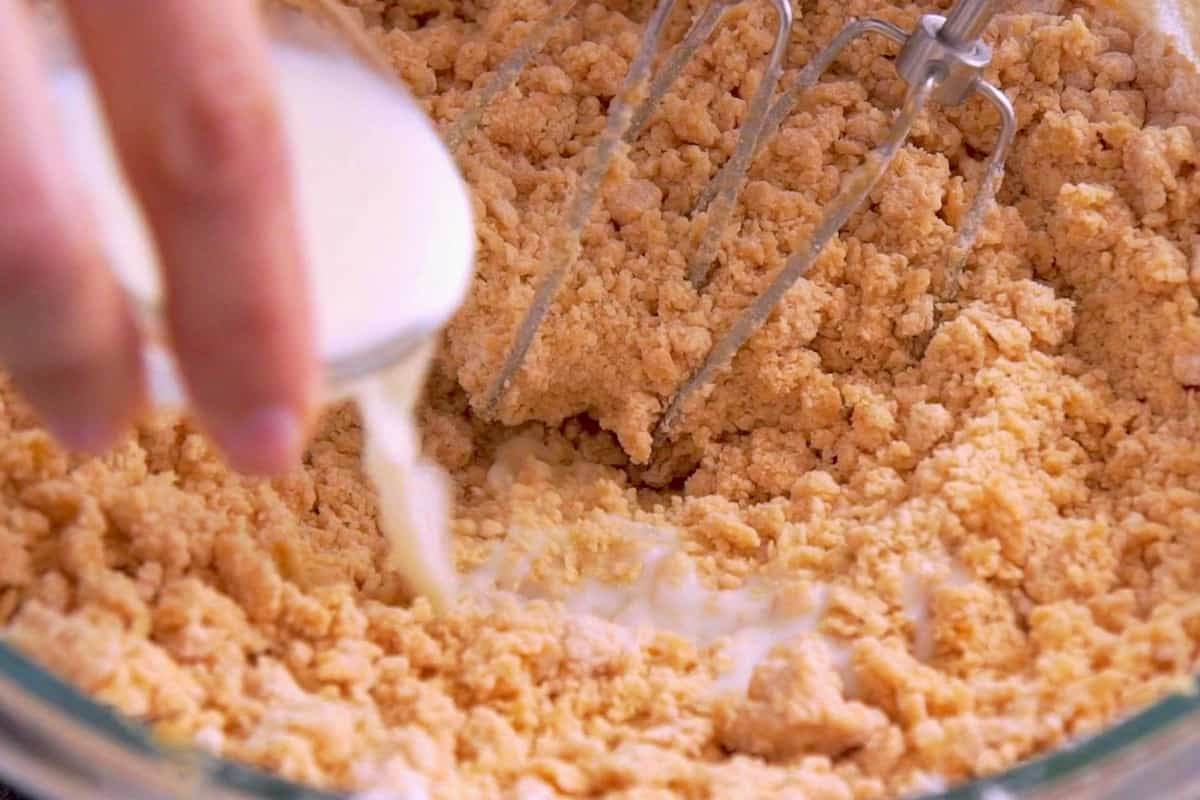 Add dry ingredients into wet mixture and use a hand mixer to combine. Then, add milk and use a spatula to finish mixing.