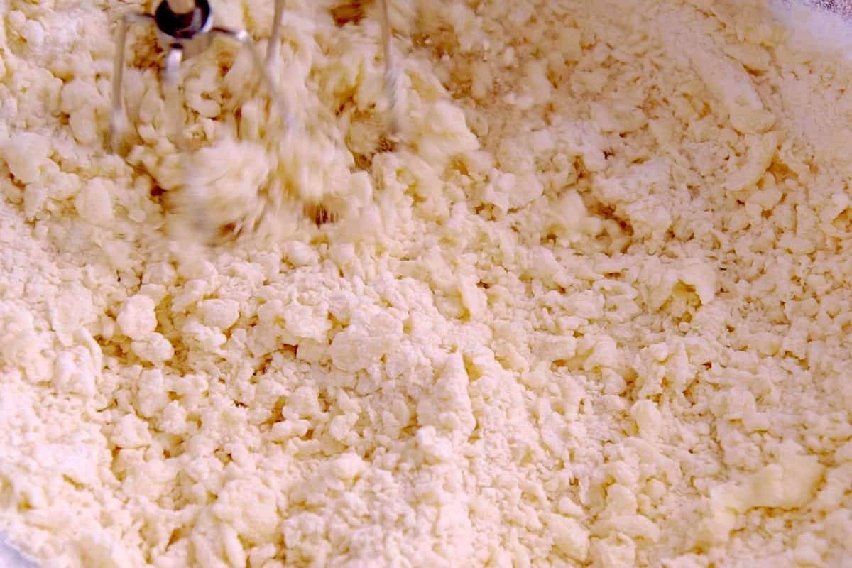 Pour dry ingredients into wet mixture, beating with hand mixer to integrate.