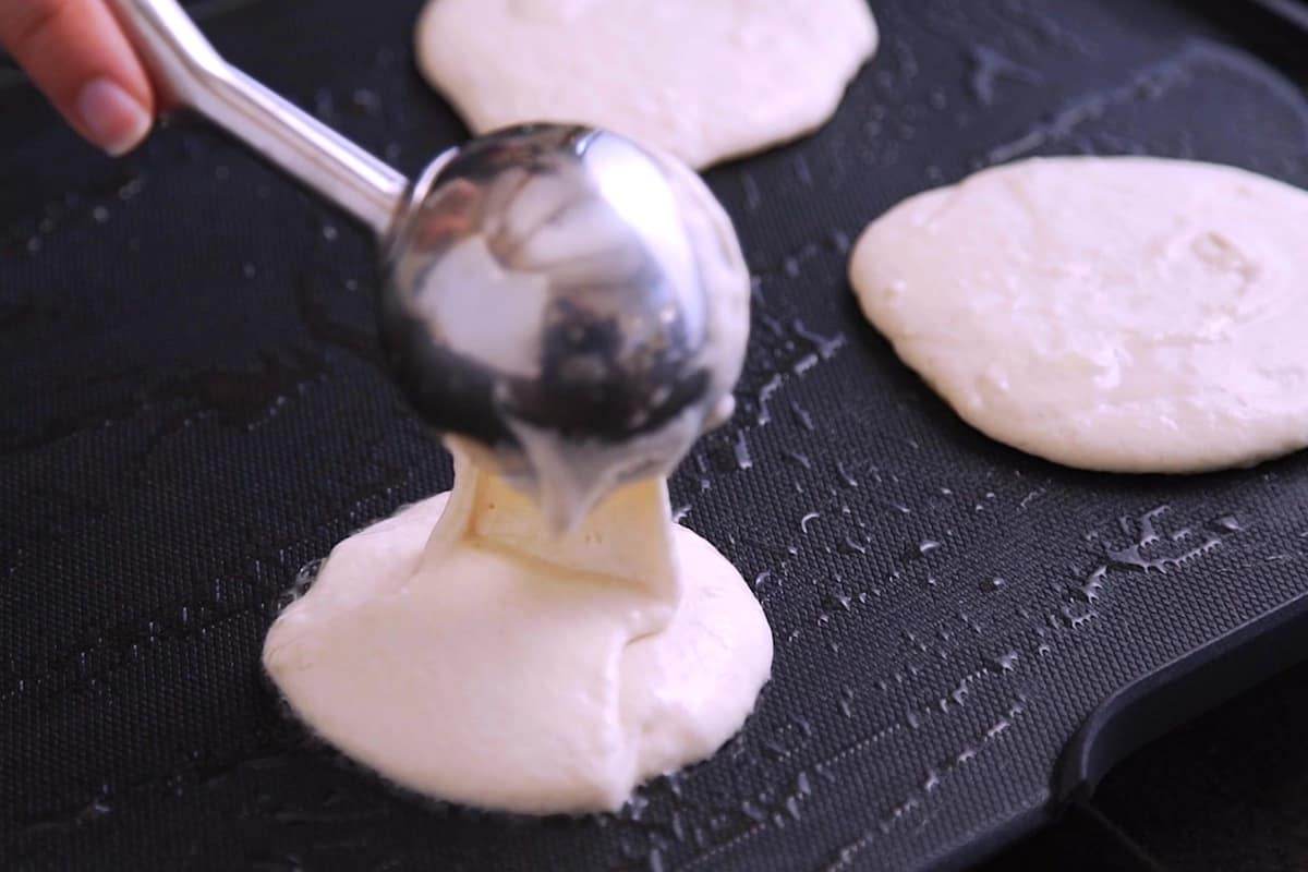 Heat pan or griddle over medium heat and grease with coconut oil. Use an ice cream scoop (or 1/4 cup) to pour batter onto heated surface.