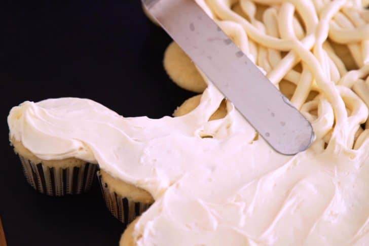 Use an offset spatula to spread frosting evenly across the cupcakes. It doesn't need to be perfectly smooth—try to intentionally create some texture with the spatula.