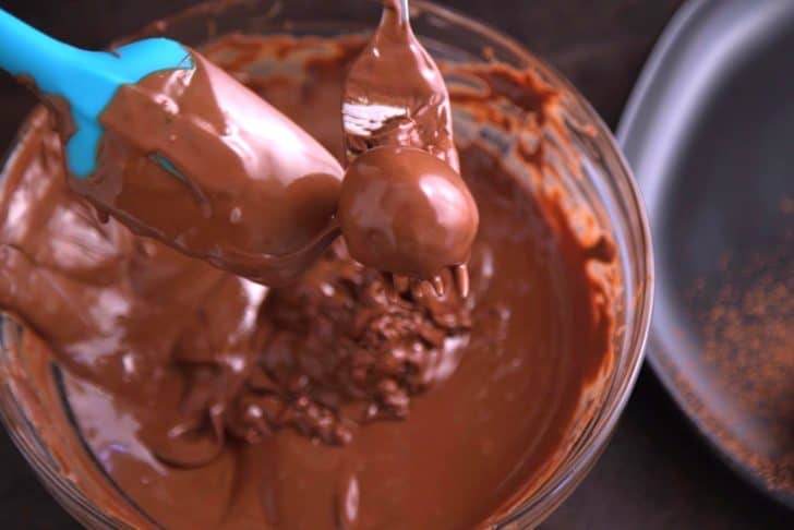 Melt chocolate of choice (either tempered or untempered) and drizzle onto firm truffles to coat.