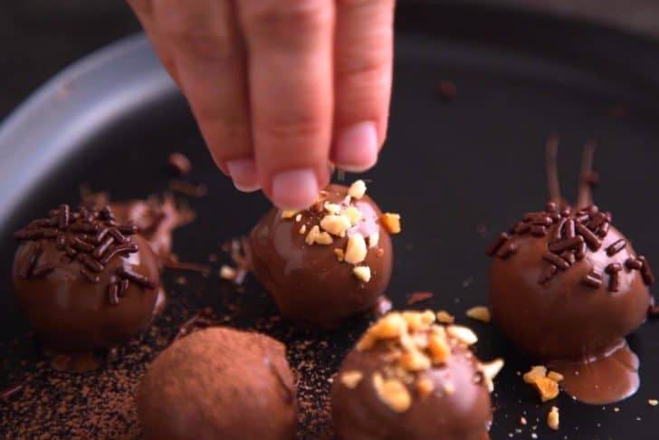 Finish chocolate truffles with desired toppings while chocolate is still wet.