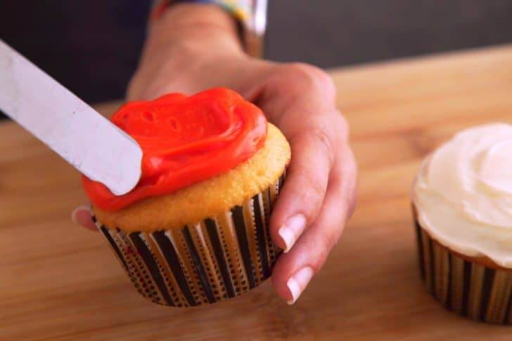 Spread frosting evenly onto cooled cupcakes.