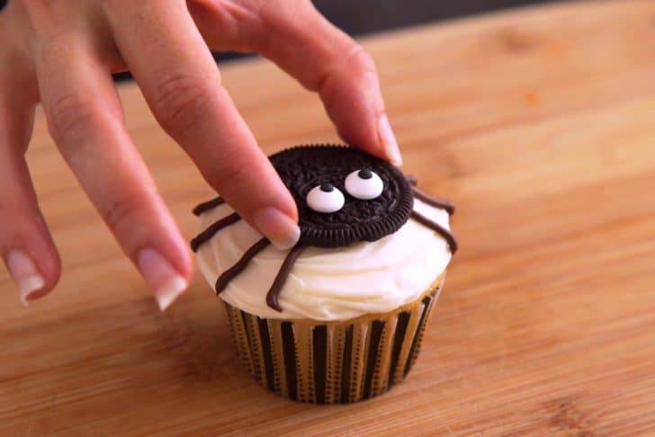 Place Oreo spider face in the middle of each cupcake, pressing gently to stick.