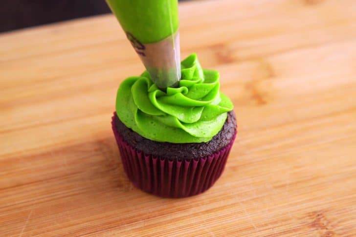 Pipe frosting of choice onto cooled cupcakes, using a decorating bag and an open star piping tip (#1m).