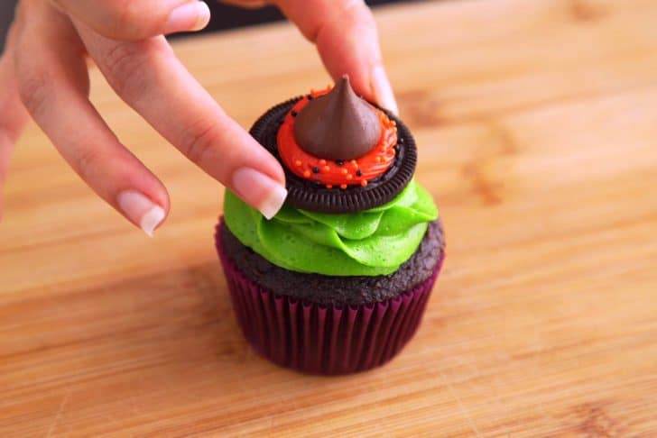 Place Oreo hat topper onto frosting and gently press so it sticks.