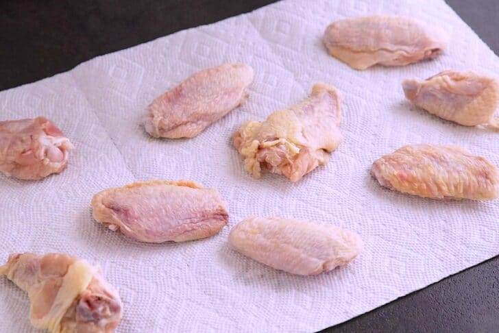 Before cooking, pat wings dry between paper towels.