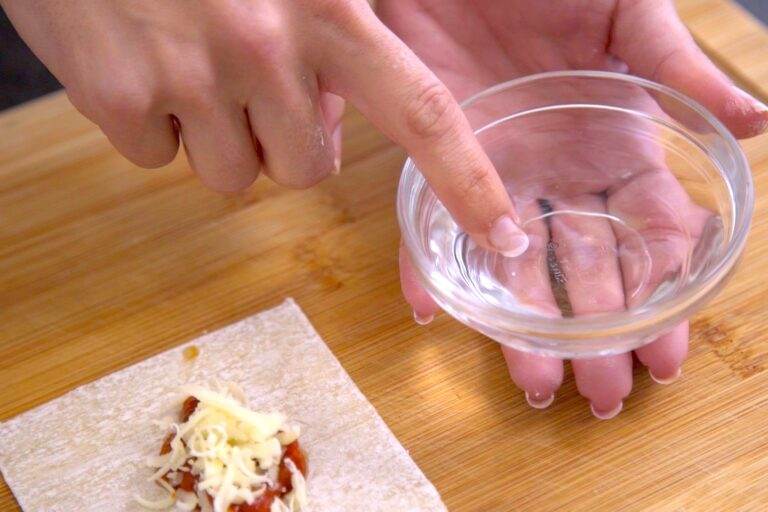 Dip a finger in water to wet the edges of the wonton wrapper.