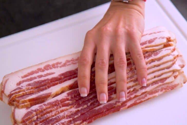 Remove frozen bacon from package, letting the slices stay stacked on each other.