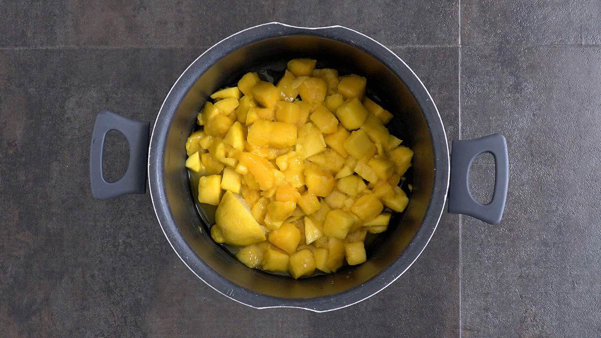Add chopped mango, lemon juice, lemon rind, and a splash of water to a pot. Cover and cook over low heat for ~30 minutes.