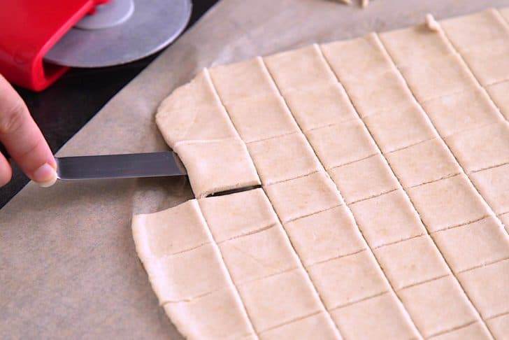 Cut rolled dough sheet into 1-inch rectangles and transfer to a lined baking sheet.