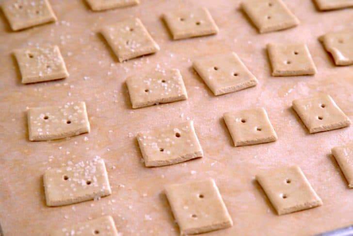 Poke holes in each cracker with a toothpick or fork, spray lightly with cooking spray, and sprinkle with salt flakes. Bake at 350°F (180°C) for 10-12 minutes.