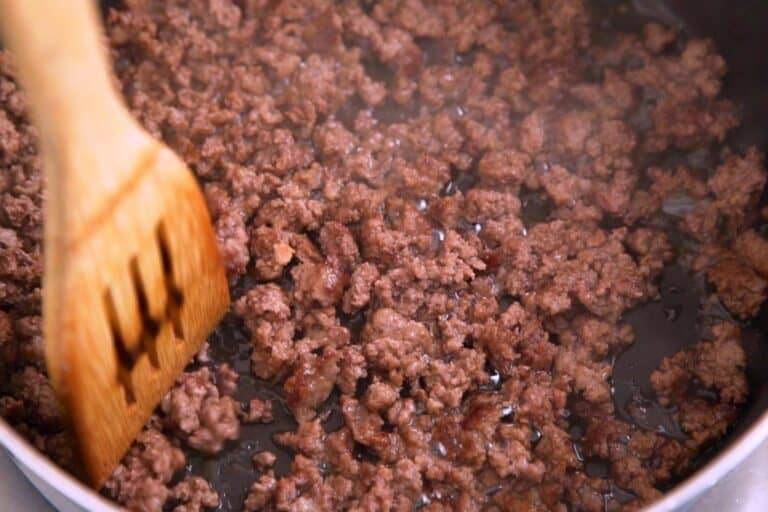 To use homemade taco seasoning mix, first cook and crumble ground beef (or meat of choice) in a pan.