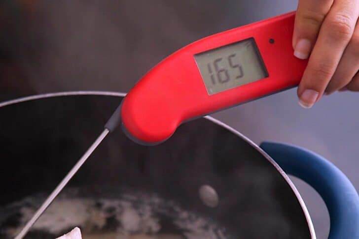 Chicken is cooked through when it reaches an internal temperature of 165°F (75°C).