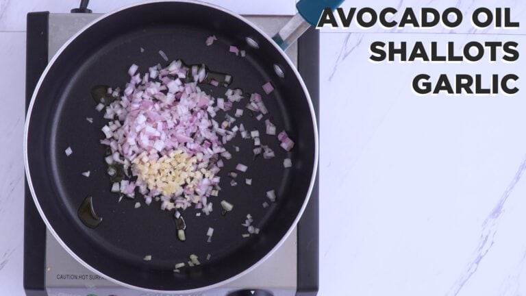Cooking shallots and garlic in a pan over medium heat.