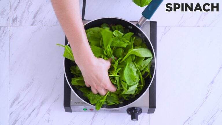 Adding spinach into the pan and cover until wilted and reduced.