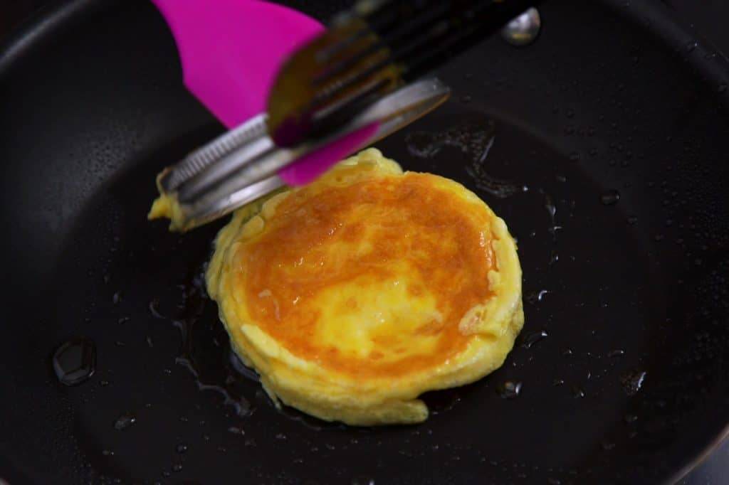 Flip egg patty when set and carefully remove mason jar lid before adding cheese