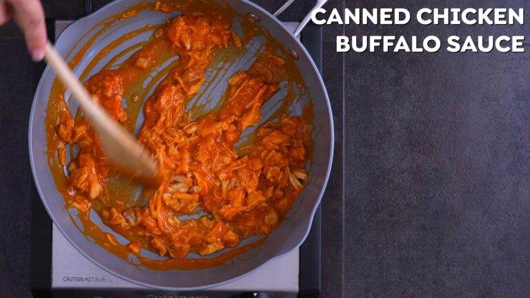 Heating buffalo sauce and chicken in a pan.