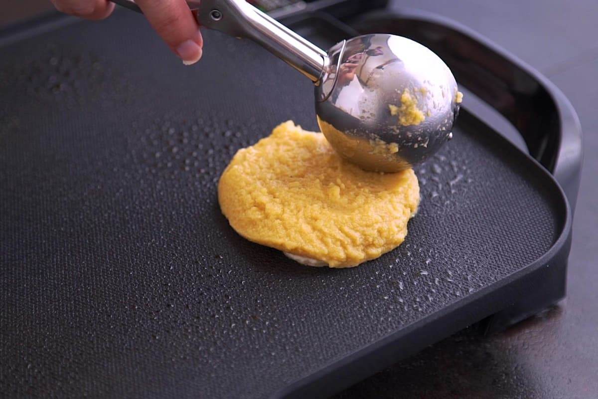 Scoop coconut flour pancake batter onto griddle with an ice cream scoop (or 1/4 cup) and flatten gently to form pancakes.