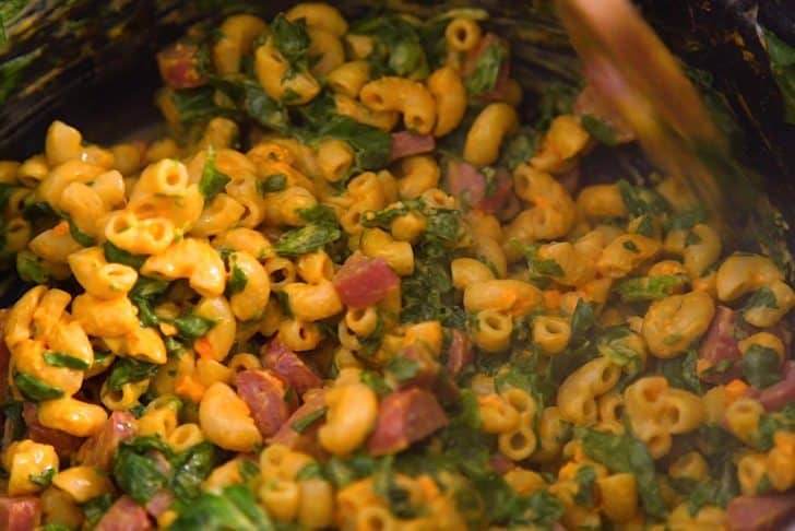 Add chopped hot dogs and spinach, then cover and allow to wilt for a few minutes.
