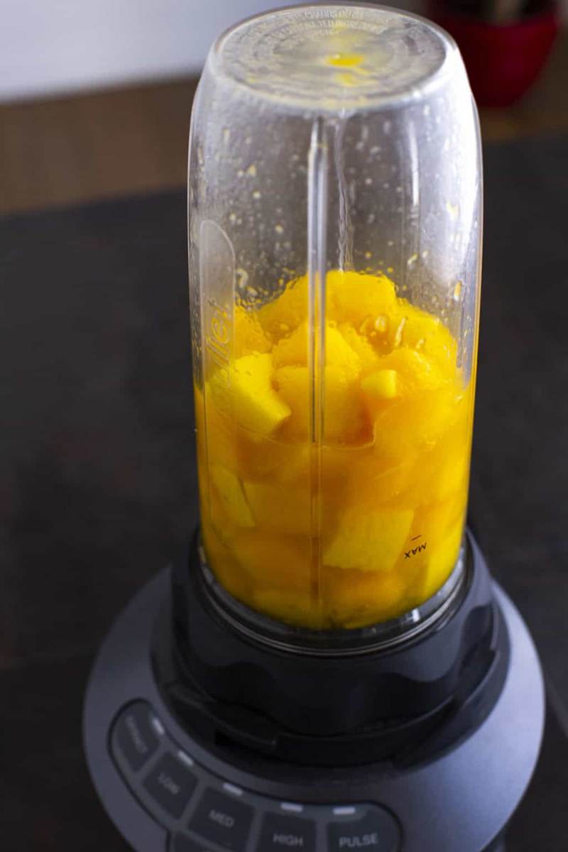 Add ripe, fresh mango to a blender or food processor.