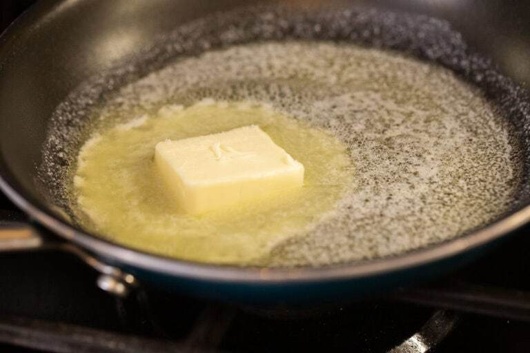 A black pan with melting butter.