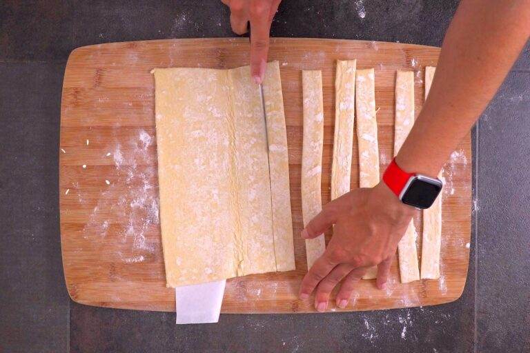 Let frozen puff pastry sheet thaw at room temperature for 20-40 minutes. Then, unfold pastry sheet on a floured surface and cut into strips 3/4-inch thick.