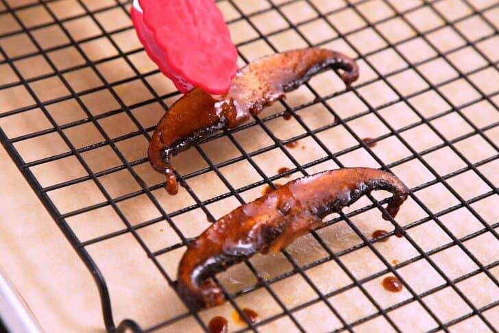 To bake in the oven, place marinated mushroom bacon on a wire baking rack on a lined baking sheet, leaving some space between the strips.